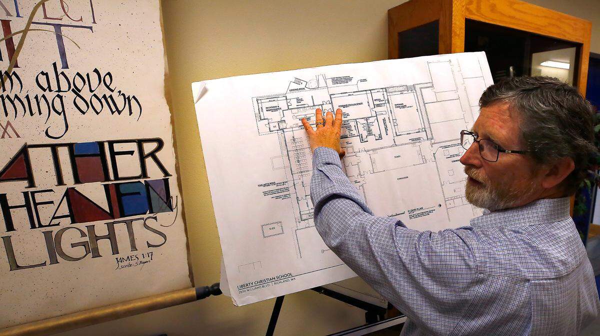 Jim Cochran, superintendent at Liberty Christian School in Richland, holds up a blueprint showing planned renovations.