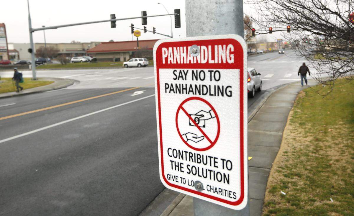 A city street sign posted on Kennewick Avenue near Highway 395, an area frequented by homeless panhandlers, encourages motorists to support local charities instead of directly donating to people on street corners.