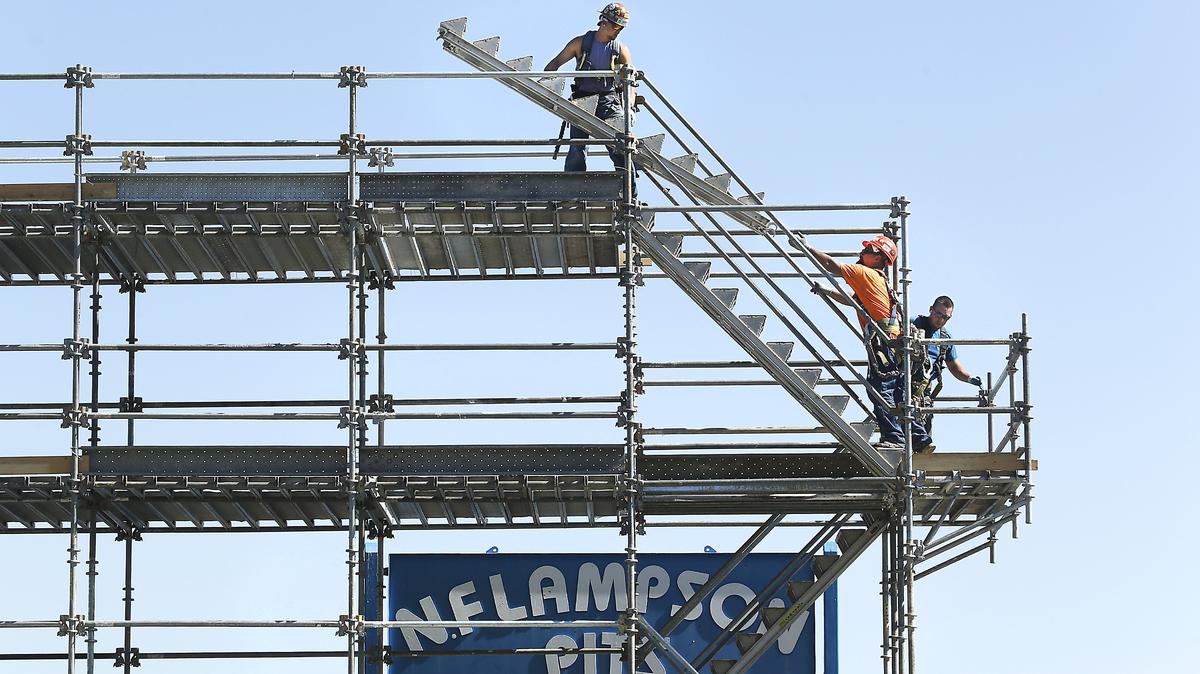 Volunteers Joe Willis, Rosario Armenta and David Turcotte work on assembling the scaffolding platform in the Neil F. Lampson Pits for this weekend’s Tri-Cities Water Follies boat racing and airshow event. The temporary structure along the Columbia River in Columbia Park will provide a vantage point for racing boat crew members and photographers. The three-day event starts July 27.