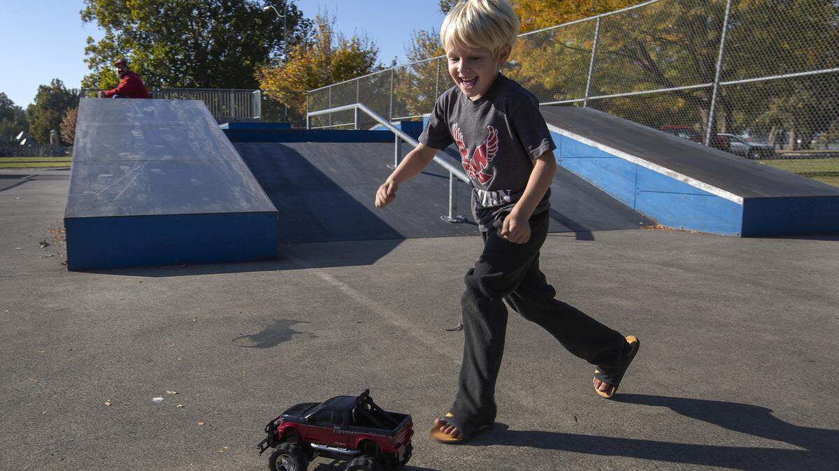 Five-year-old Kenzi Carter chases after a remote controlled truck driven by his dad, Kraig Carter. The two had the truck zipping around the skate park in Columbia Park in Kennewick on a sunny Tuesday. According to the National Weather Service, the sun will be back Wednesday with 68-degree highs. But first comes patchy fog before 11 a.m.