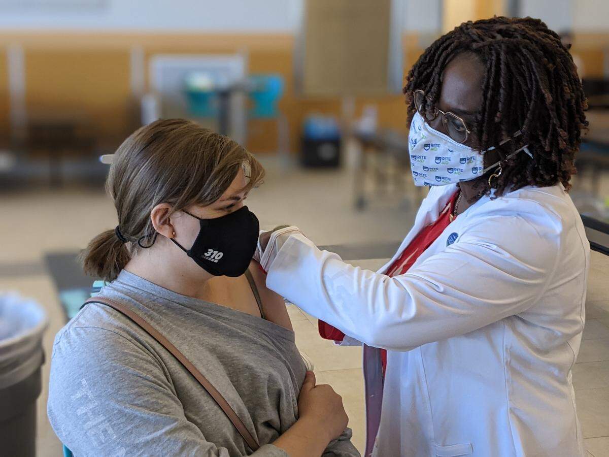 A Delta High student gets a COVID vaccination at the school Friday during a student-led event.