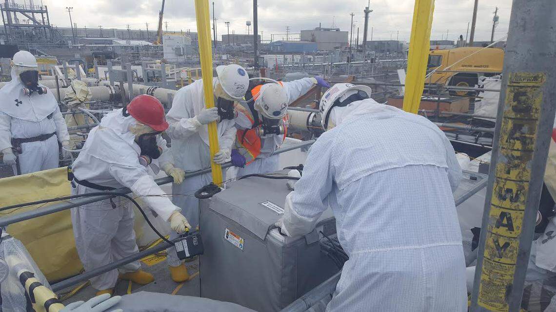 Hanford site workers installed remotely operated equipment in underground Tank AX-103, before starting to remove up to 1 million gallons of radioactive and hazardous chemical waste.
