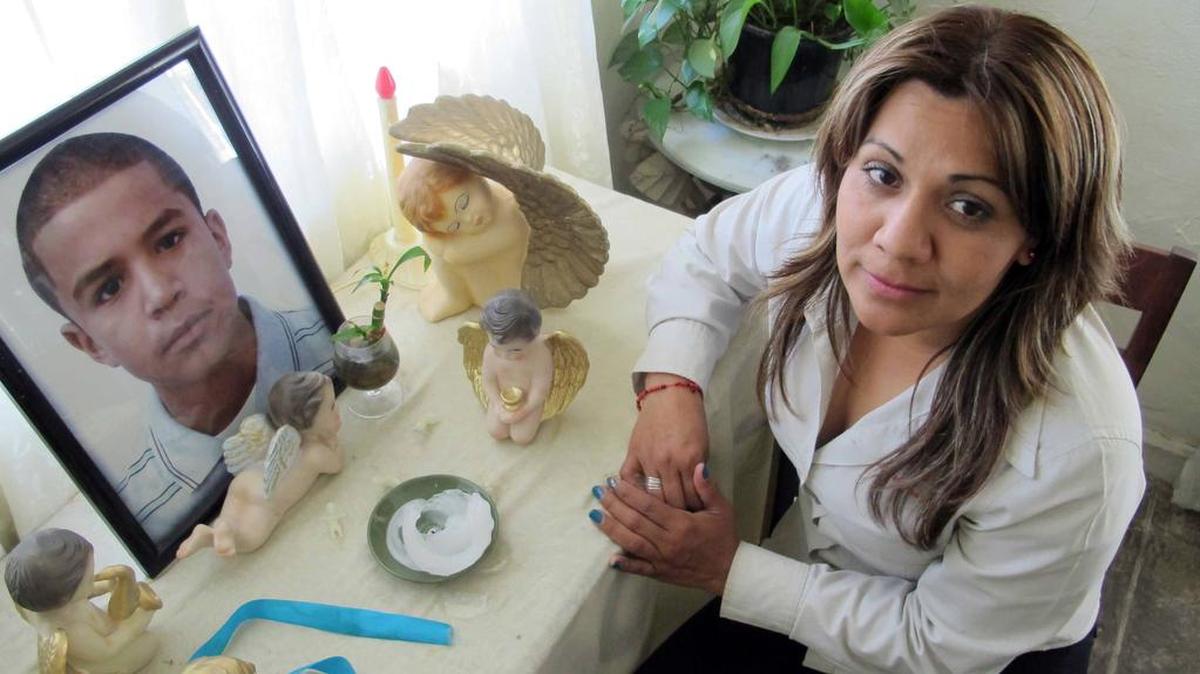 Araceli Rodriguez sits in her home in Nogales, Mexico, March 12, 2014, next to a small shrine she's made to honor her son Jose Antonio, a 16-year-old who was gunned down in 2012 by the U.S. Border Patrol.
