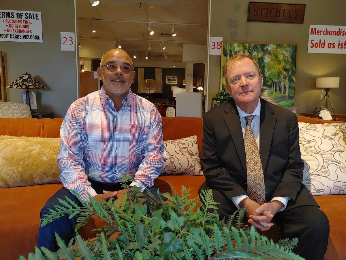 Rene Vasquez, sales manager at Ennis Fine Furniture, and owner David Ennis pause for a moment before the Richland business opened its doors for a retirement store closing sale on July 31. Ennis, 62, sold the building to La-Z-Boy and is retiring after more than 40 years at the Richland Wye.