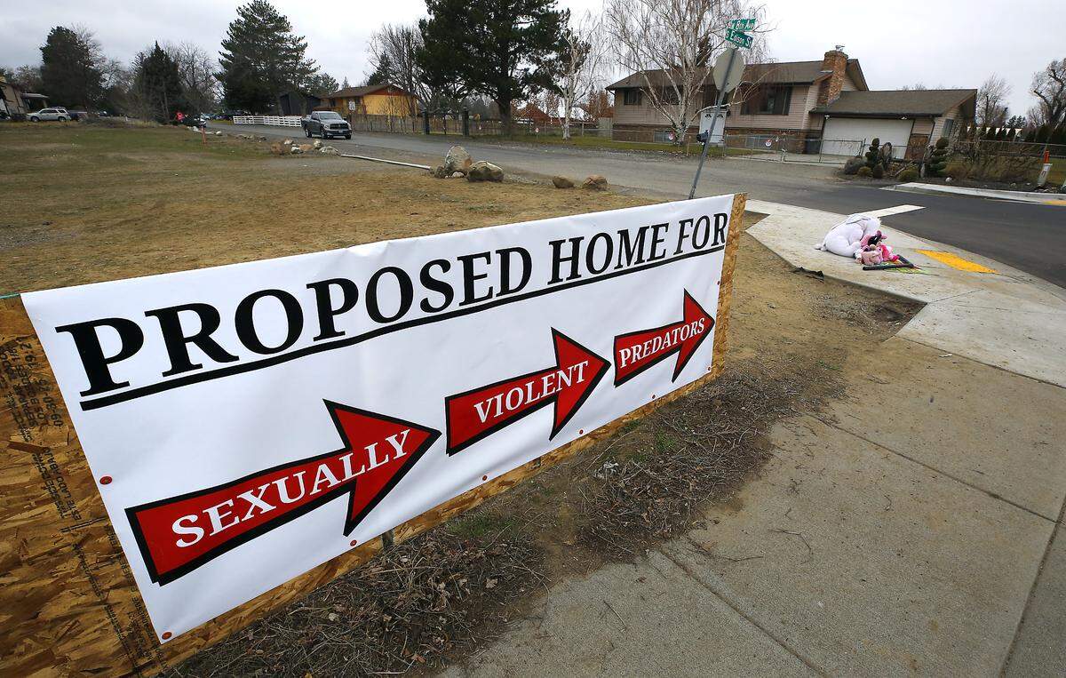 Neighbors in the area off West Eighth Avenue have placed a banner along Edison Street in Kennewick opposing the decision to allow a home for sex offenders.