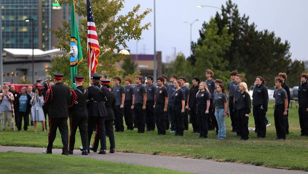 Members of the Tri-Cities Professional Firefighters Honor Guard mark the 24th anniversary of the Sept. 11, 2001, attacks Thursday morning at the 9-11-01 Memorial at Kennewick’s Southridge Sports & Events Complex. Students enrolled in the Tri-Tech Skills Center firefighting and emergency medical services classes stand at attention for the presentation of the colors.