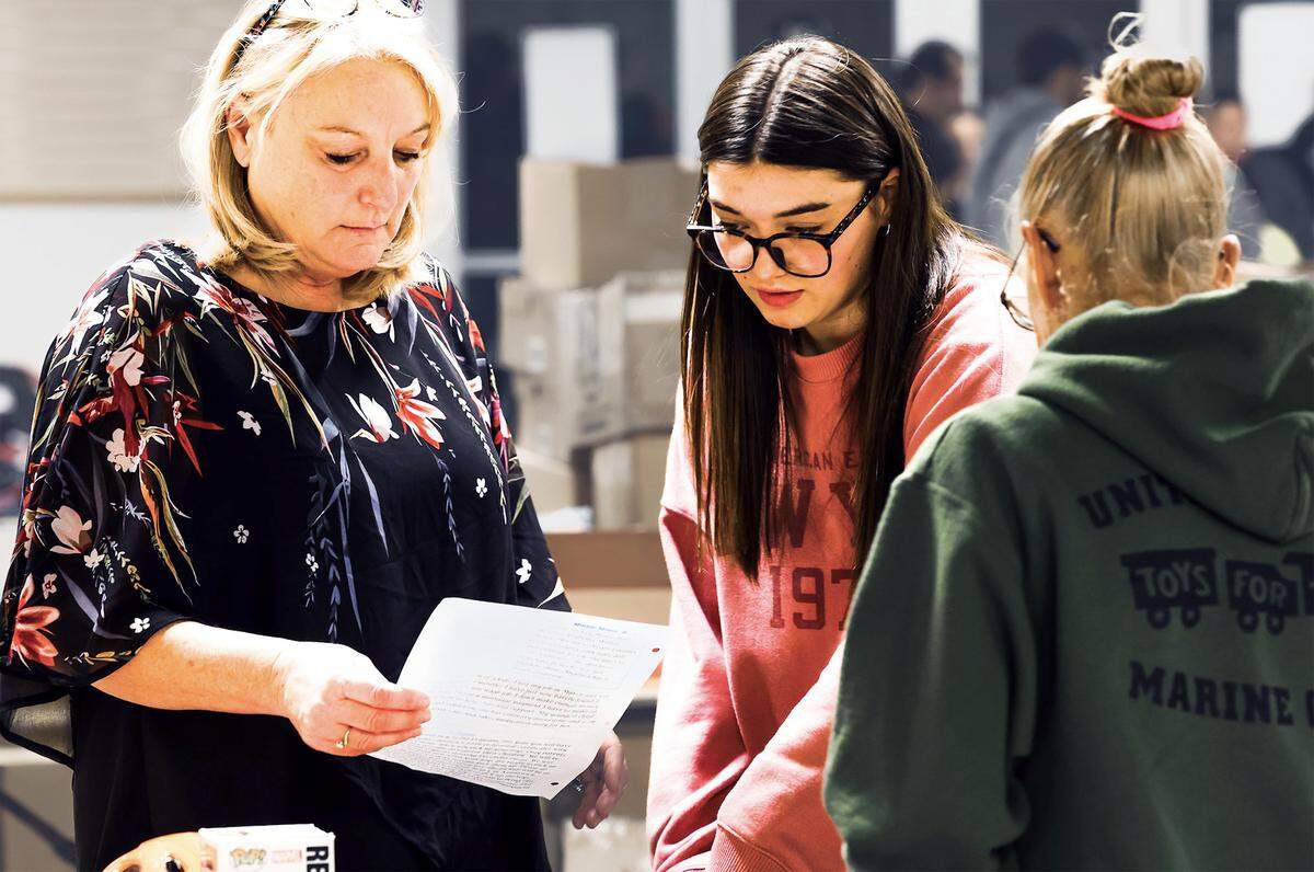 Lisa Carlin and her granddaughter Caitence Humphrey, 17, a student at Hanford High School, help sort, organize, select, and bag up the toys for the families that will get them for Christmas through the Marine Corps Reserve Toys for Tots Santa’s Workshop.