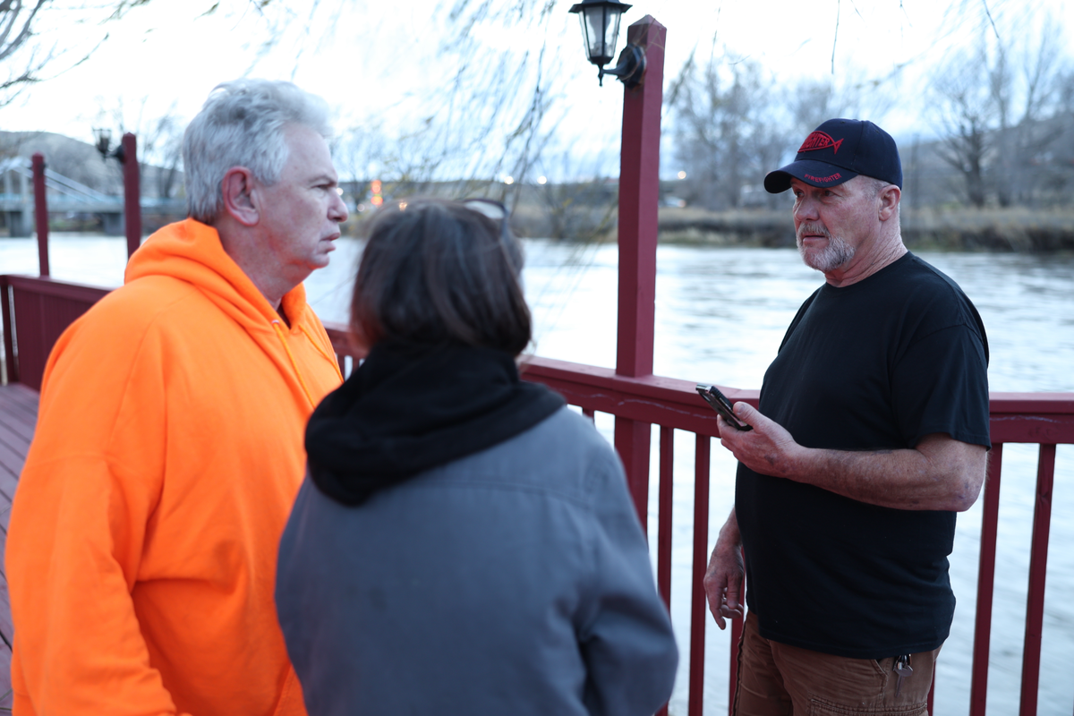 Beach RV Park residents Daniel Quinn, Candice Hutton, and Tom Grogan discuss Wednesday morning their options if they need to evacuate their homes along the banks of the Yakima River in Benton City.