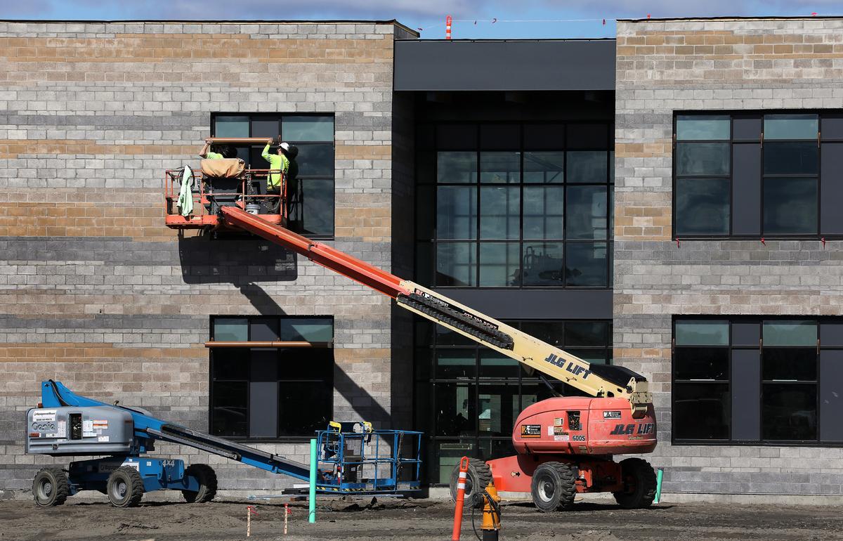 Crews work from a boom lift at the new Sageview High School under construction at 6091 Burns Road in west Pasco.