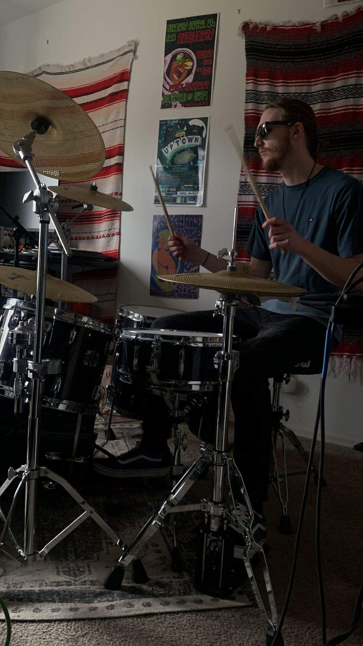 easyday’s drummer James Bruce practices on his drum set at the band’s jam space, where the band writes music and perfects songs before recording in the studio.