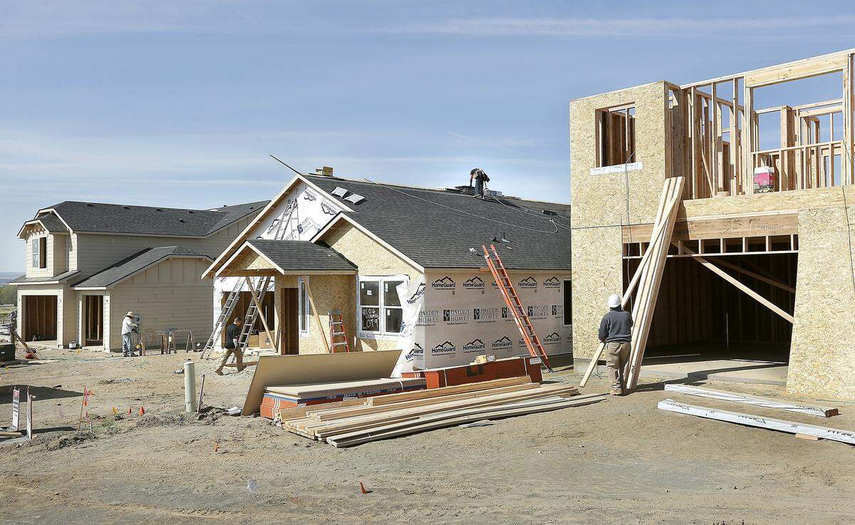 Construction workers in the Hayden Homes Riverhawk Pointe housing development work on constructing new homes recently in the the 4100 of Vermilion Lane in west Pasco. The new neighborhood is located off Road 84 and is visible from Interstate 182.