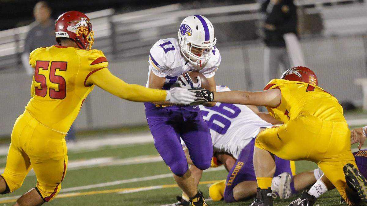 Hanford’s Jared DeVine (11) tries to run past Kamiakin’s Christian Ramos (55) during last year’s game at Lampson Stadium in Kennewick. DeVine, the top running back in the Mid-Columbia Conference last year, returns for the Falcons.
