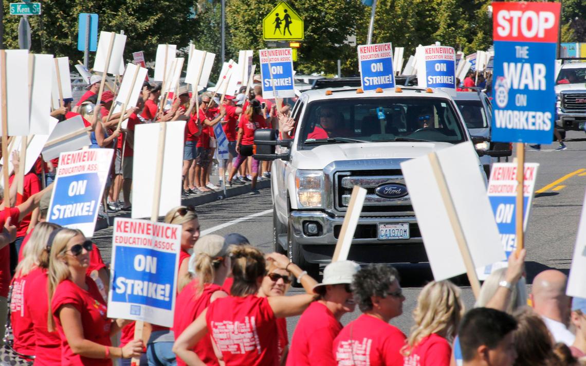 Hundreds of Kennewick teachers and their supporters line West Fourth Avenue near the Kennewick School District administration office Wednesday morning during the second day of their strike.