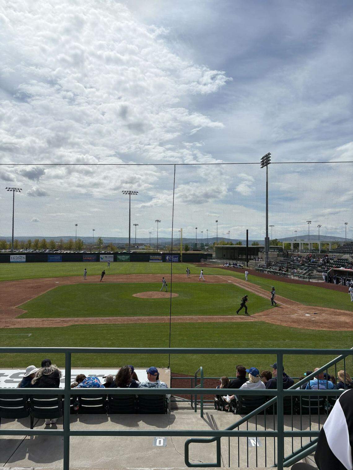 View of the Dust Devils game from General Admission seating, made up of benched rows in a higher section at Gesa Stadium.