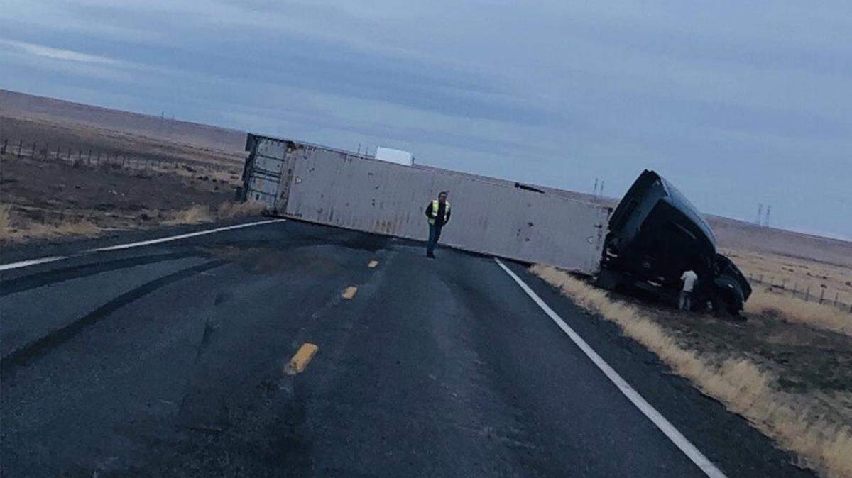 A semi truck flipped across both lanes of the Hanford highway Monday morning. Highway 240 was expected to be blocked for two to three hours.