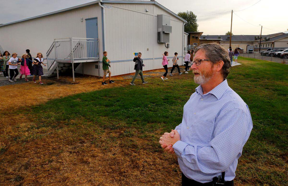 Jim Cochran, superintendent at Liberty Christian School in Richland, stands outside near three modular classroom buildings added in the past three years.