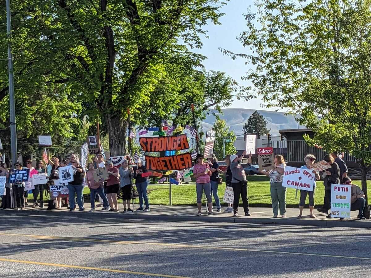 More than 400 protesters lined George Washington Way between Knight Street and Swift Boulevard on Thursday evening for a May Day demonstration. Many held signs critical of the Trump Administration, federal cuts, Elon Musk, and the Republican Party. It was organized by Indivisible Tri-Cities.