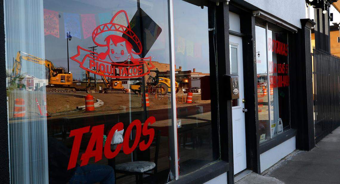 Heavy construction equipment for the Lewis Street overpass project is reflected in the window of the Piqui Tacos Mexican restaurant at 218 W. Lewis Street in Pasco.