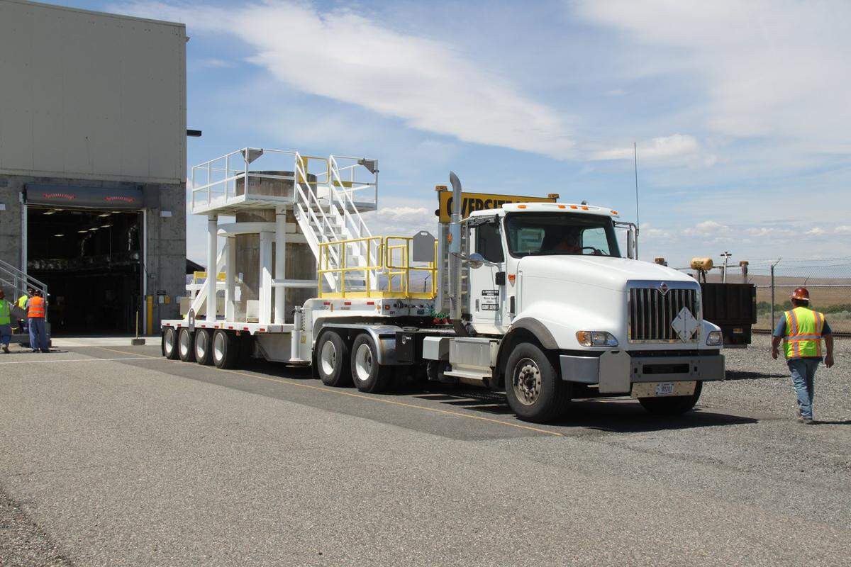 A cask holding radioactive sludge is loaded for the drive to central Hanford to be placed in dry storage.