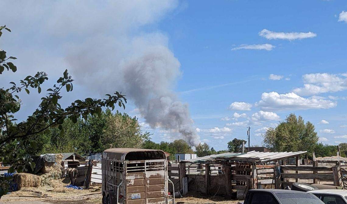 The plume from a freezer warehouse fire in Finley can be seen from a backyard several miles away.