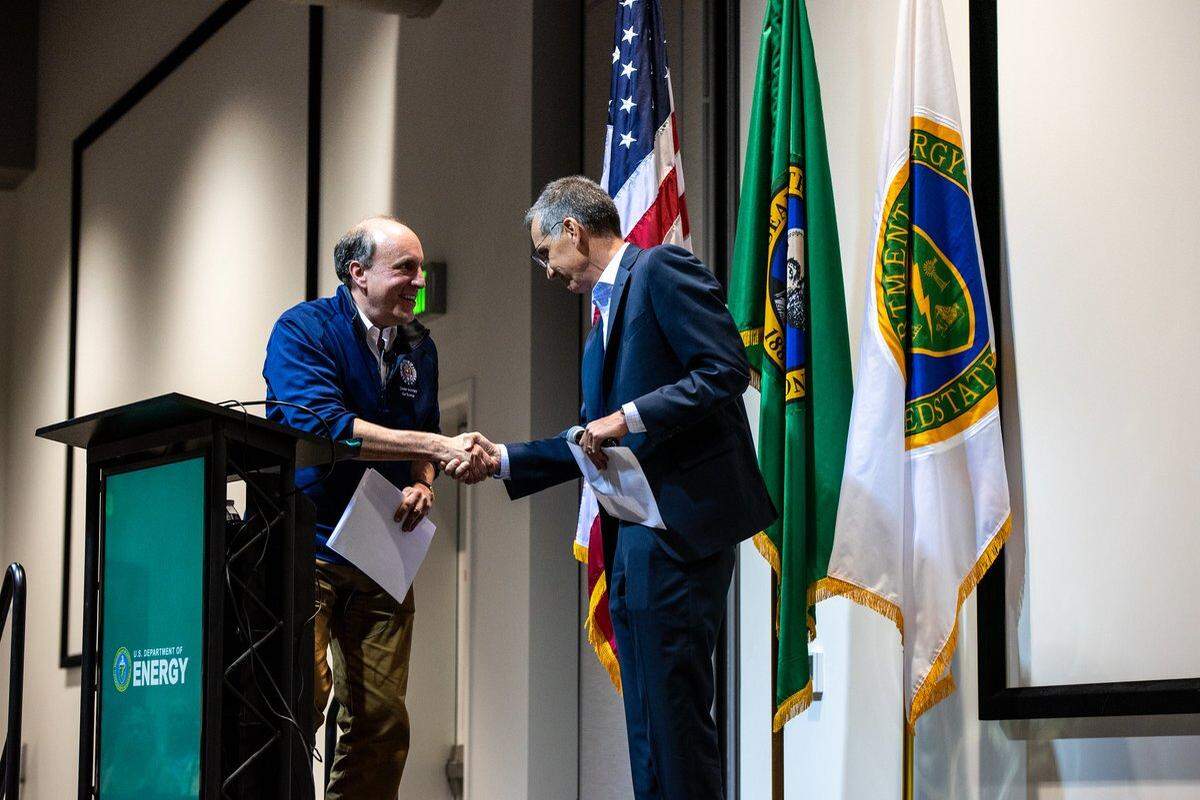 Department of Energy Under Secretary Paul Dabbar, left, shakes hands with DOE Hanford manager Brian Vance before an all-hands staff meeting in Richland last week.