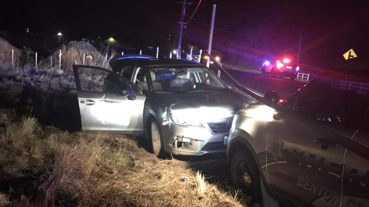 A Benton County deputy forced a fleeing car to stop after the driver allegedly pointed a gun at another driver on Interstate 82 Sunday.