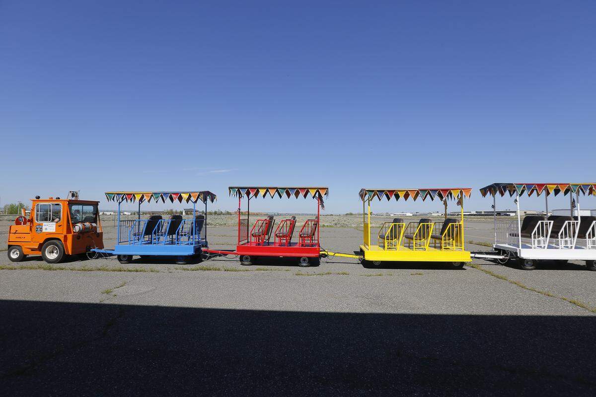 J&S Dreamland Express train pulls out of an old Vista Field airport hangar in Kennewick on its way to Columbia Park.