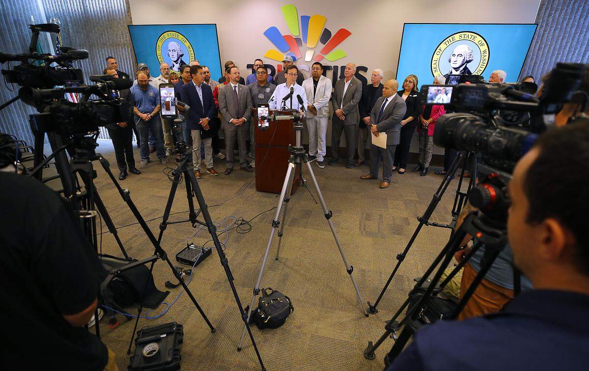 Wash. Gov. Bob Ferguson speaks at a news conference Friday about the Department of Energy's possible plan to delay or cancel startup of the Hanford Waste Treatment Plant next month. State, tribal and community leaders stand behind him at the TRIDEC office in Kennewick.