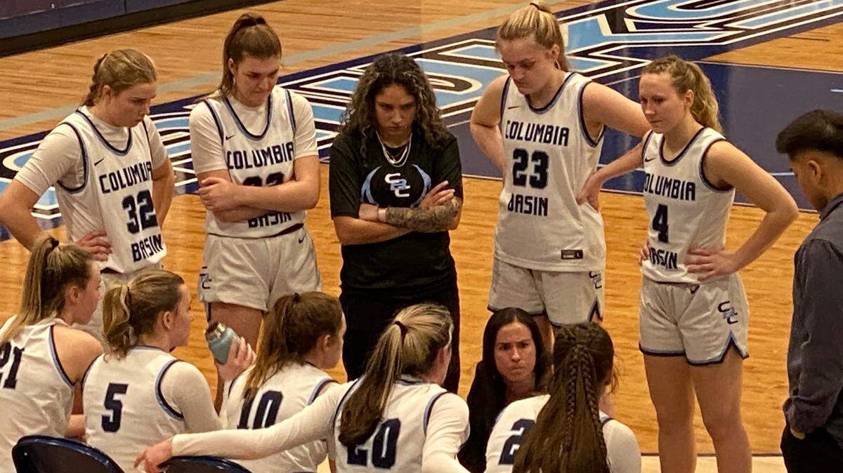 Columbia Basin College women’s basketball coach Amy Sokaitis, center bottom, speaks with her team during Thursday night’s game in Pasco.