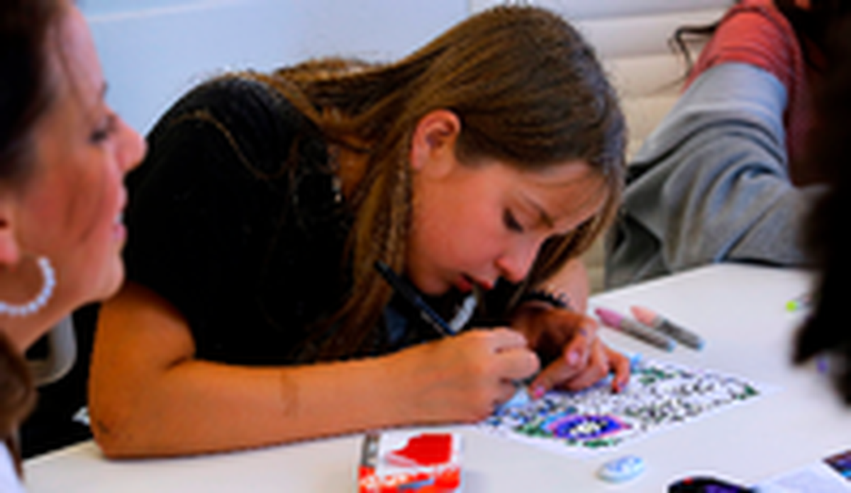 Annaleigh Trujillo, a member of the Boys & Girls Club of Benton and Franklin Counties, works on decorating a “worry stone” to hold whenever they feel anxious or worried about something.