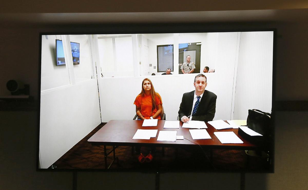 Suspect Claudia Yesena Rizo appears for her arraignment on a closed-circuit television screen Monday with provisional defense attorney Michael Quillen in Franklin County Superior Court.