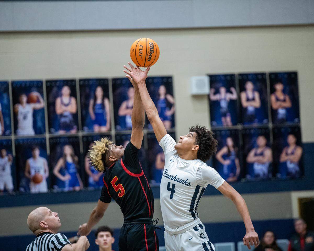 Chiawana’s Donavin Young stretches for a tip off when they played the Kamiakin Braves in January. The Chiawana boys earned a berth into the 4A state basketball tournament this week.