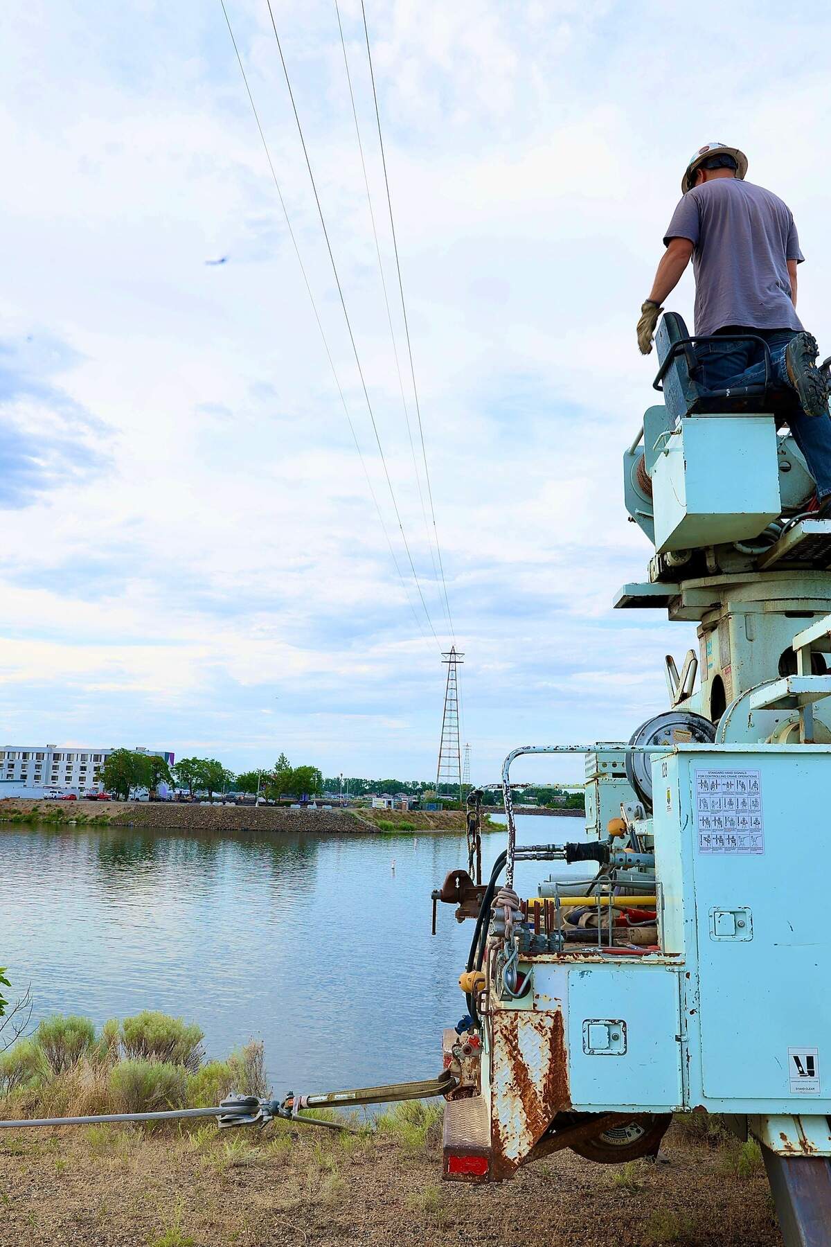 Benton PUD crews work to repair a damaged power line near Clover Island in Kennewick after a floatplane broke the wire and crashed into the Columbia River killing two men onboard.