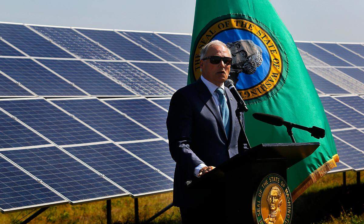 Washington Gov. Jay Inslee prepares to sign a series of climate action bills Wednesday morning at the Horn Rapids Solar Farm, a collaborative solar energy, storage and training facility at 2800 Horn Rapids Road in Richland. Inslee, who recently announced he’s not running for re-election, surrounded himself with state legislators and other dignitaries during the press conference.