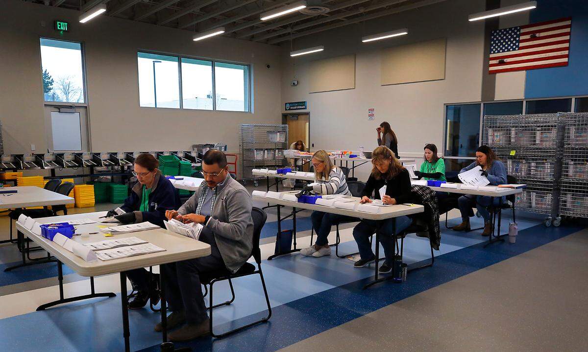 Benton County election workers begin the mandatory manual recount for the Benton Public Utility District on Monday morning in Kennewick.