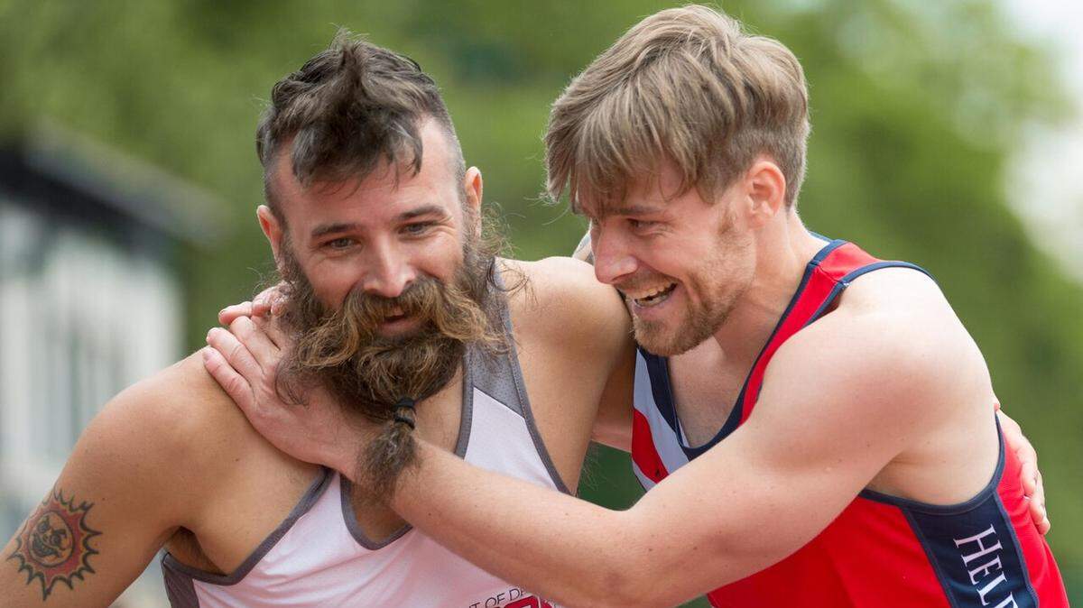 Army veteran Fred Lewis, left, a member of the U.S. Special Operations Command team, and U.K. team member Corbin Mackin, a British army veteran, react to finishing a men’s 200-meter race together during the 2016 Department of Defense Warrior Games at the U.S. Military Academy in West Point, N.Y., June 16, 2016.