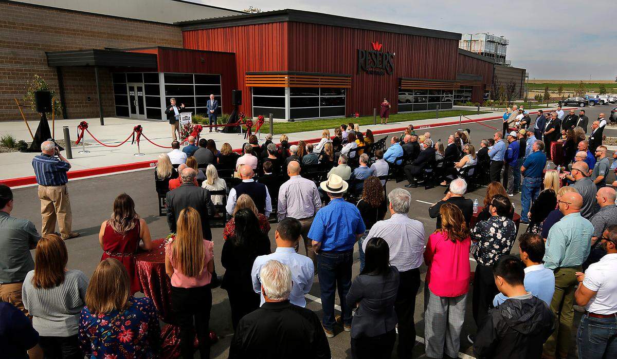 Mark Reser, president of Reser’s Fine Foods, speaks to a crowd during Wednesday’s celebration outside the food company’s newest production facility in Pasco, Wash. The plant will make the company’s signature potato salad and more.