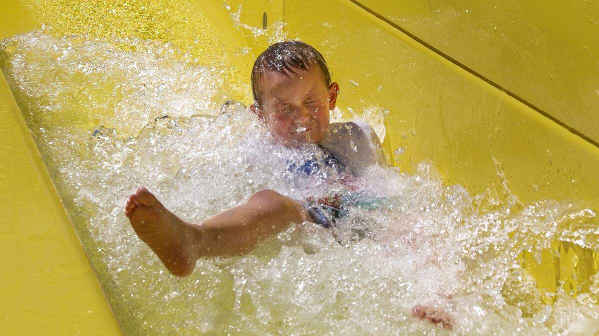 Michael Jarrett, 4, slides down Mr. Twister, a 28-foot water slide, on a hot Wednesday morning in Splash Down Cove at the Tri-City Court Club in Kennewick. Michael was with his mother, Michelle Jarrett of Richland. Thursday’s high will be 98 degrees in Kennewick, according to the weather service.