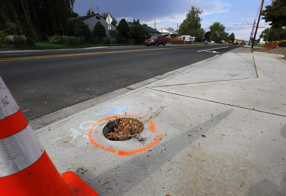 Police investigative paint outlines where a damaged utility pole was removed after a 2007 Mercedes being driven by Ashante Q. Sanders-Jackson, 22, lost control and rolled on Van Giesen in Richland.