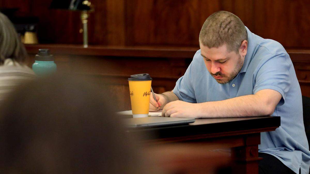 Murder suspect Joshua D. Davis appears to write notes Monday before the start of his first-degree murder trial in Franklin County Superior Court in Pasco.