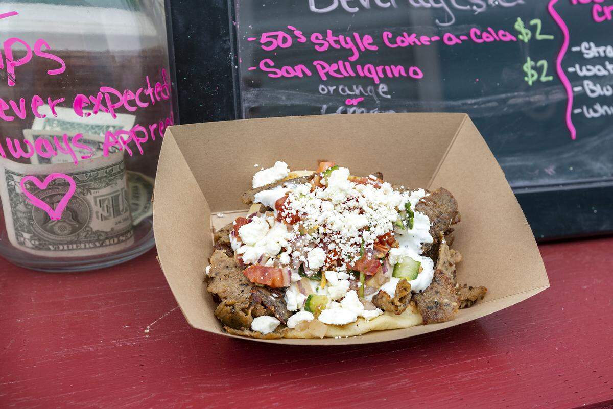 Gyro Sandwiches with traditional gyro meat or chicken with home made tzatziki, cucumber, tomato, onion & basil salsa topped with feta cheese in naan bread.