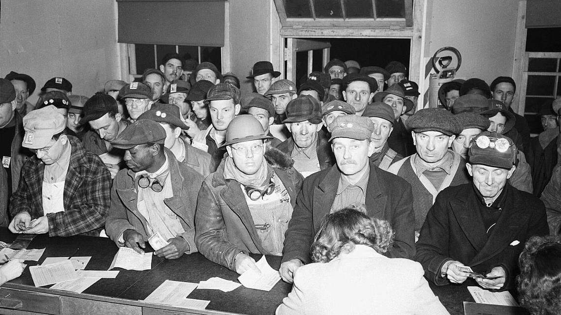 The Western Union office at Hanford nuclear reservation was packed on a 1944 pay day with men waiting to send money home. Other photos show the line stretching outside.