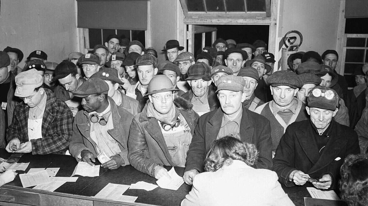 The Western Union office at Hanford nuclear reservation was packed on a 1944 pay day with men waiting to send money home. Other photos show the line stretching outside.