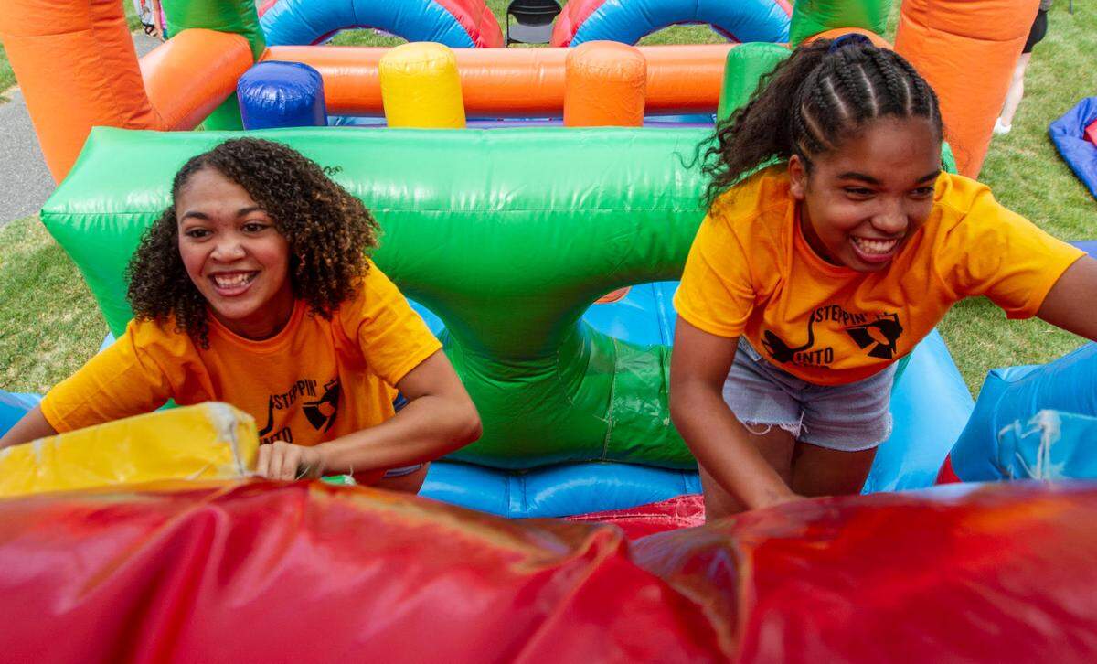 KaeDence Mirisciotta, left, and Jordan Perkins, right, race through a bounce house agility course during the 2021 Juneteenth celebration at Kurtzman Park in Pasco on Saturday.
