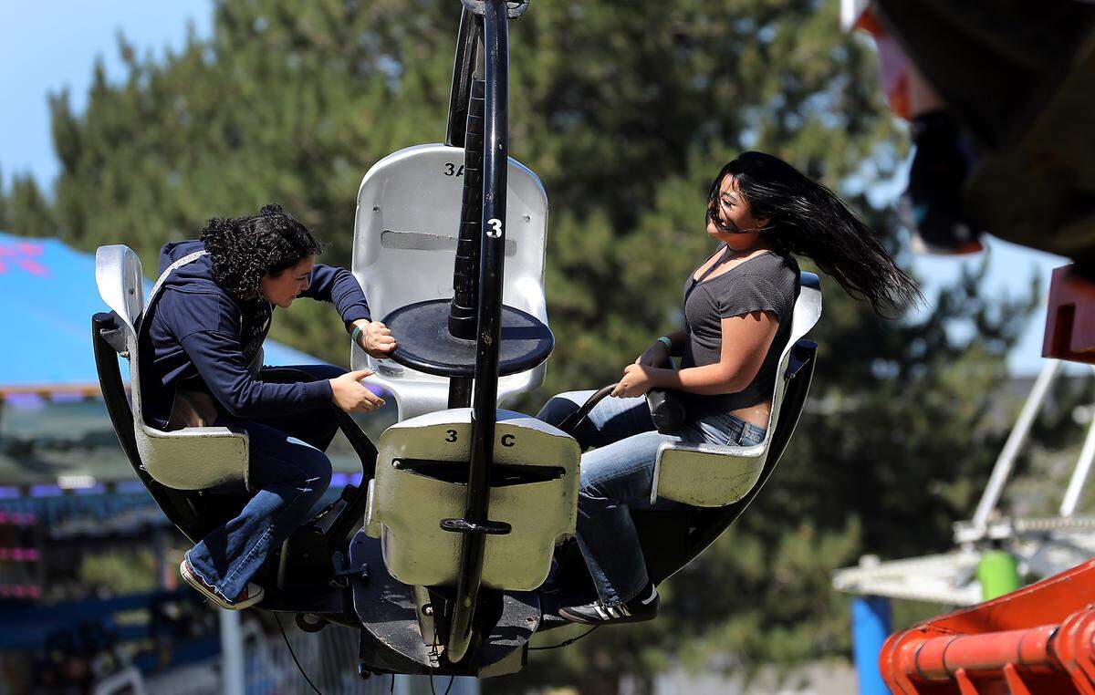 Riders on the Tornado get a double-spin Friday afternoon in the Davis Shows Northwest carnival area at the Benton Franklin Fair & Rodeo in Kennewick.