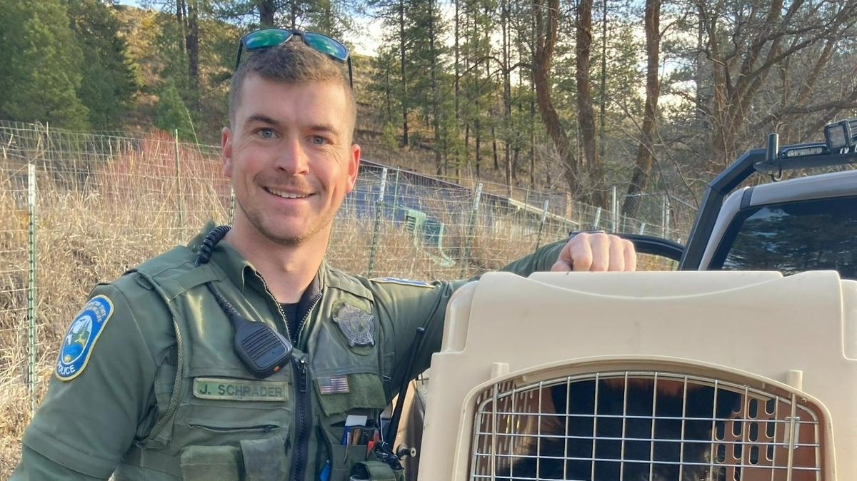 Jacob Schrader, an enforcement officer for Washington Department of Fish and Wildlife Police, was recently honored for saving the lives of four people in a year. He’s shown here with a bear cub.