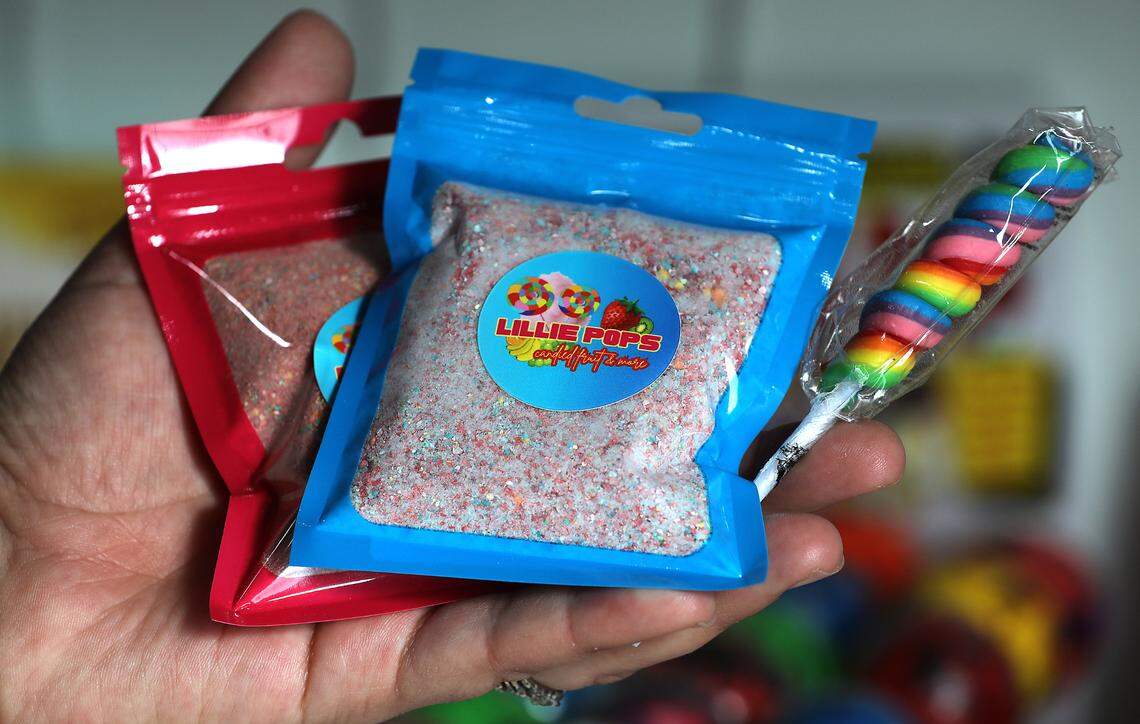 Sarra Hendrick holds up candy she named for her daughter, Lillie, 6, that’s for sale inside JoJo’s Freeze-Dried Goods manufacturing space and candy store east of the Tri-Cities Airport.