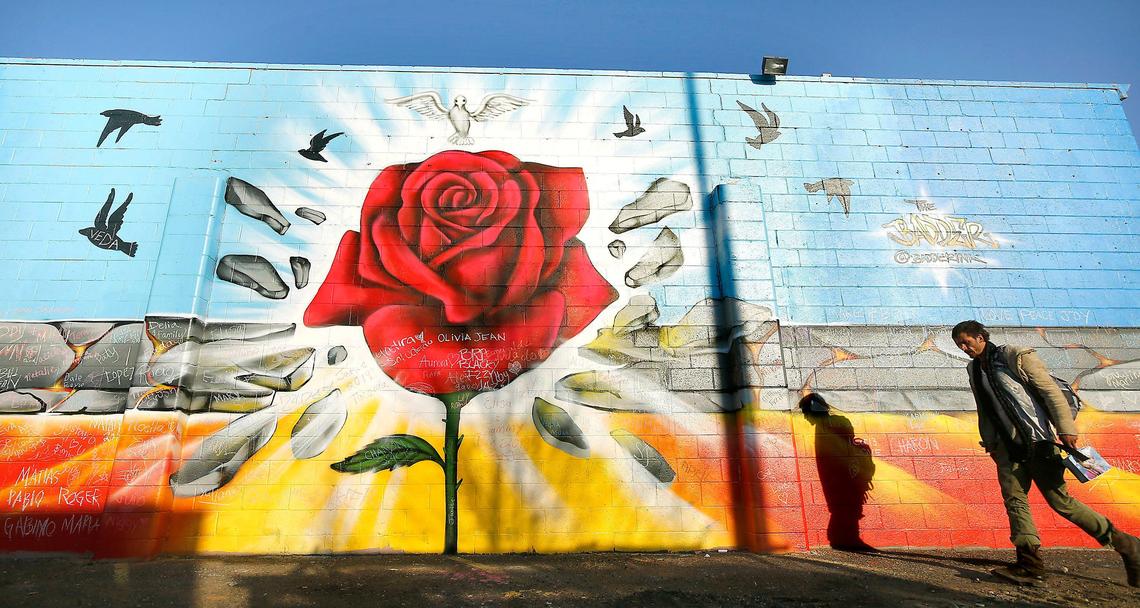 A man walks past the original Community Hope Wall mural on the side of the former Vinny’s Bakery building on Lewis Street near 10th Avenue in Pasco. The mural was unveiled during a Nov. 2019 ceremony.