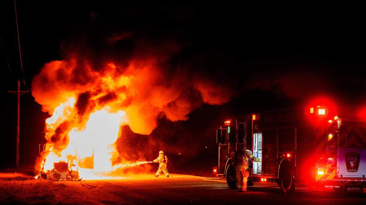 A Franklin County firefighter sprays water on a fully engulfed semi-truck late Thursday night on Selph Landing Road just west of Taylor Flats Road near Franklin County Fire District 3 station 33. No one was injured, and crews were on scene for about 30 minutes after knocking down the flame and cleaning up.
