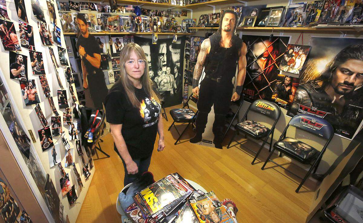 Avid wrestling fan Debbie Deweber stands in a room of her Pasco home filled with her wrestling memorabilia. The Road to Wrestlemania event Feb. 16 is the first super show to come to Tri-Cities with WWE superstars Roman Reigns, Seth Rollins, Becky “The Man” Lynch and others. Watch a video at: tricityherald.com/videos
